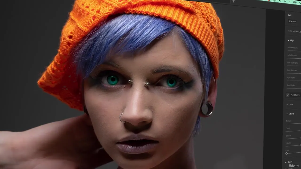 Close-up portrait of a person with blue hair and an orange hat displayed in a photo editing interface with visible adjustment sliders.