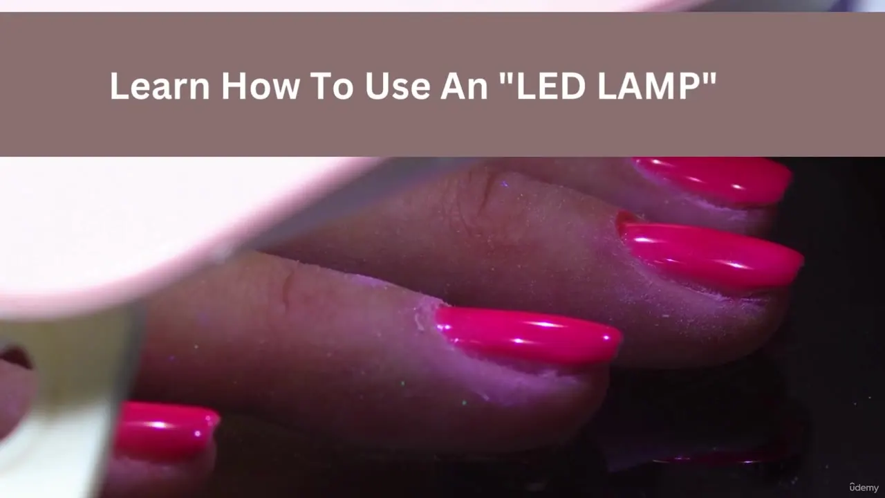 Close-up of a hand with bright pink gel nails being cured under a white LED lamp, with a text overlay at the top.