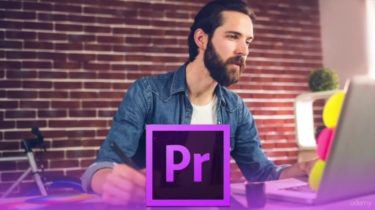 A bearded man in a denim shirt sits at a desk with a laptop and stylus, with a large Adobe Premiere Pro logo overlay in the foreground.